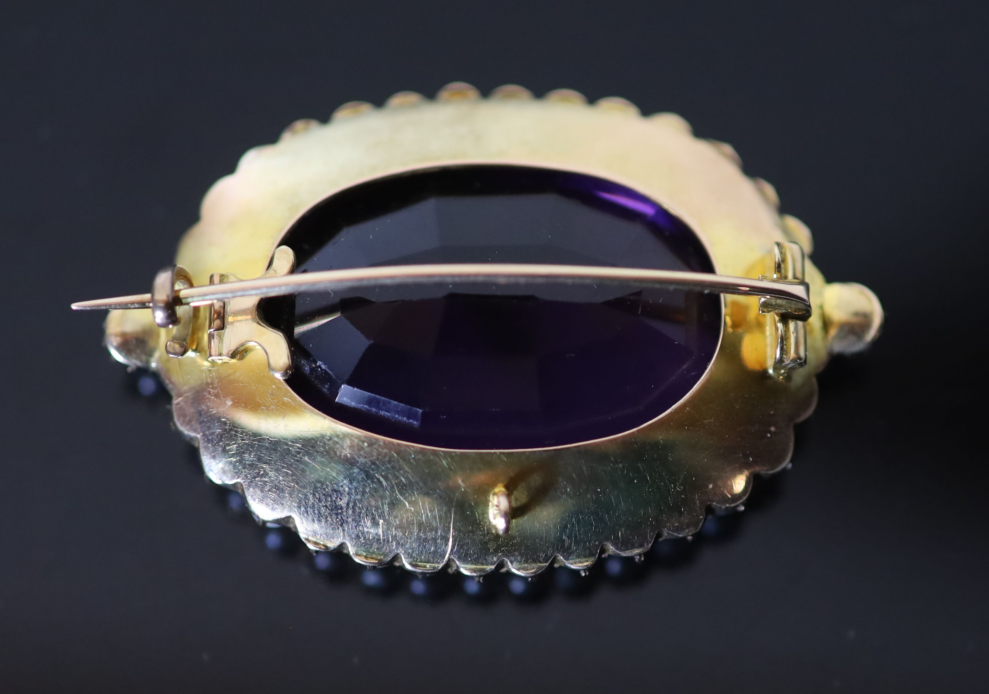 A Victorian style, gold, oval cut amethyst and split pearl cluster set brooch,